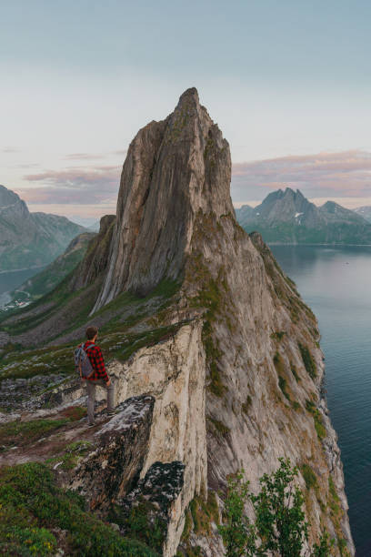 istock Man walking near  mountain on Senja island 1217444329