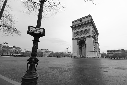 Place Charles de Gaulles (place de l'étoile) with the Arc de Triomphe being empty during the lockdown (coronavirus, COVID-19). In Paris, France.