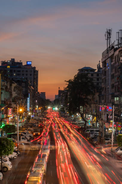 istock YANGON, MYANMAR - DECEMBER 15, 2018: Traffic flows through the city streets at dusk. 1217444635