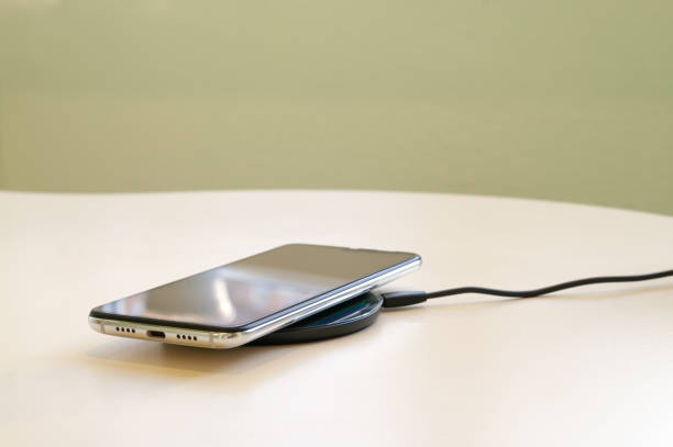 istock Smartphone wireless charging on induction charger. Wireless charger. Copy space 1217444826