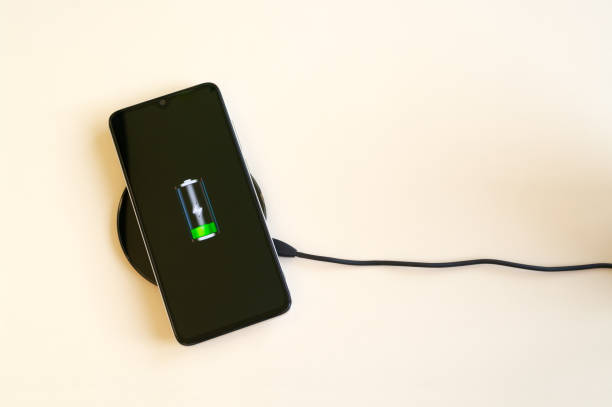 istock Smartphone wireless charging on induction charger. Wireless charger. Copy space 1217444827