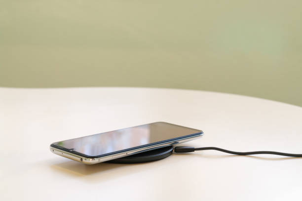 istock Smartphone wireless charging on induction charger. Wireless charger 1217444828