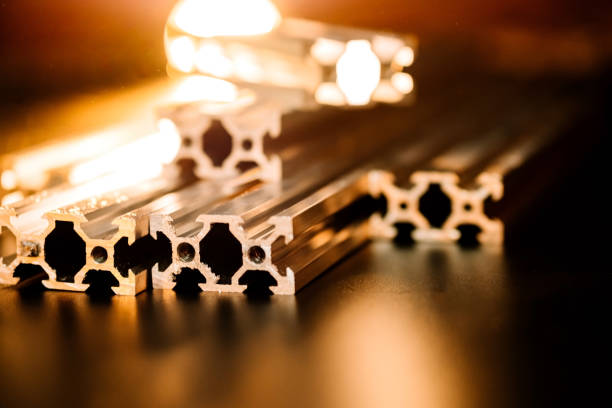 v slot aluminum profile lies on a black table, work surface with a bright lantern. how to assemble a cnc machine do it yourself