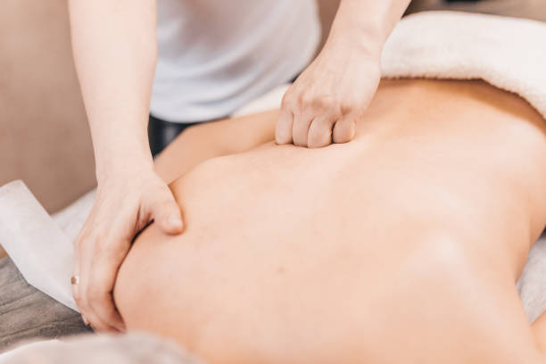 istock Back massage technique - female masseur hands 1217449285