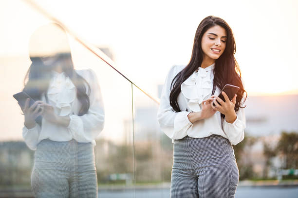 istock Happy businesswoman using smart phone 1217449476