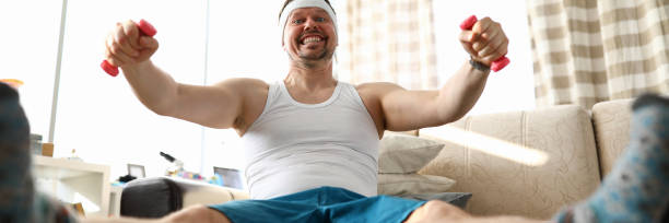 istock Funny smiling man sitting on fit ball working out 1217450393