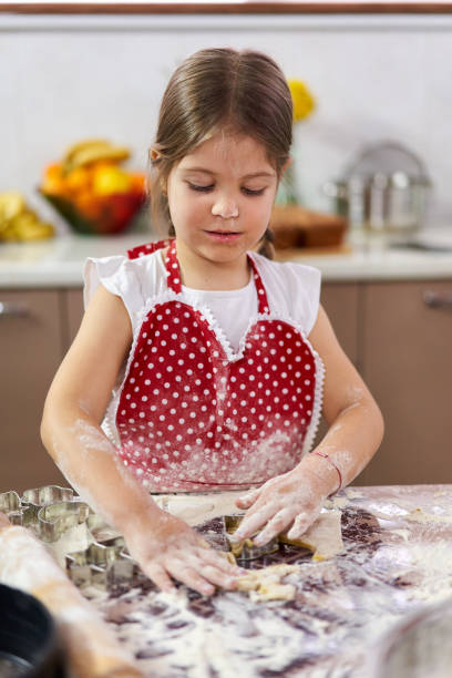 istock Girl making gingerbread cookies 1217450535