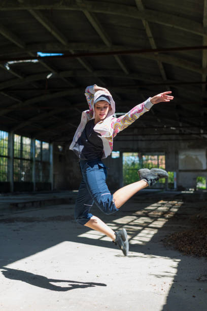 istock Hip hop female dancer dancing in abandoned building 1217450918