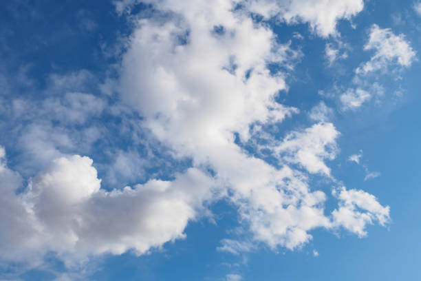 istock Cumulus clouds on blue sky in sunny spring day, nature background. 1217452057