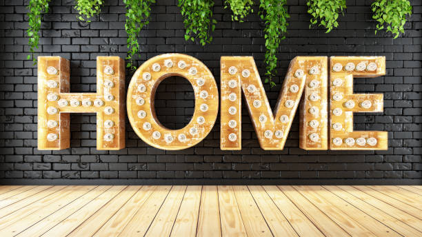 istock Home Light Bulb Sign on Black Brick Wall 1217452361