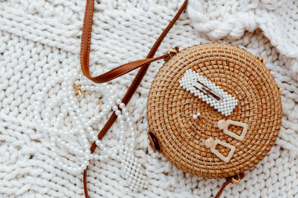 istock Closeup rattan bag with accessories over wool blanket 1217453360