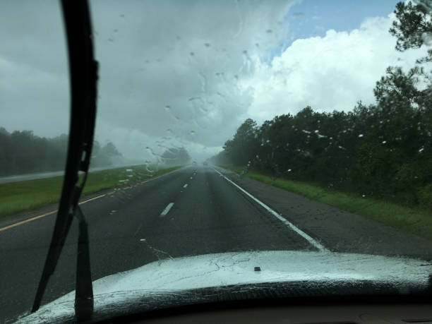 istock Driving down interstate with wipers on, about to enter area of heavy rain 1217453675
