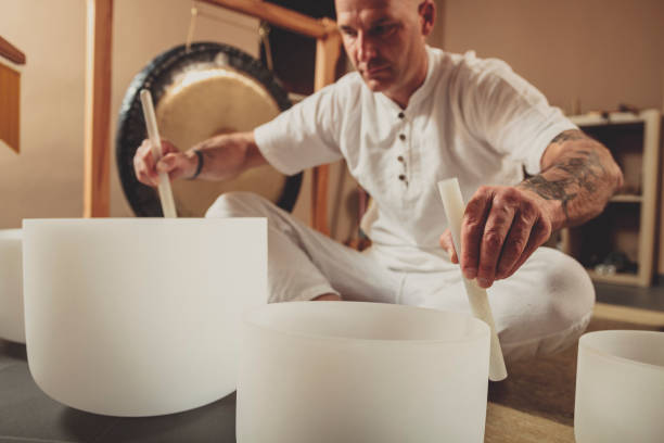 Adult man playing crystal bowl stock photo