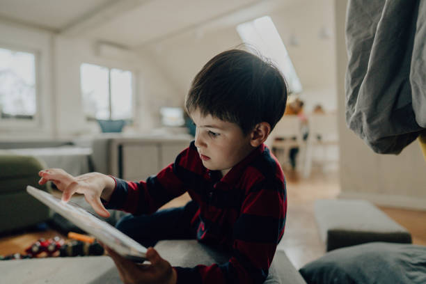 istock Little boy watching cartoons on digital tablet 1217455023