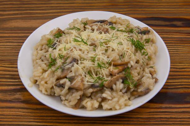 istock Tasty appetizing risotto on  white plate on  wooden table 1217457476