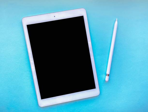 istock Tablet mock up on table with stylus isolated on blue background. Business concept. 1217462499