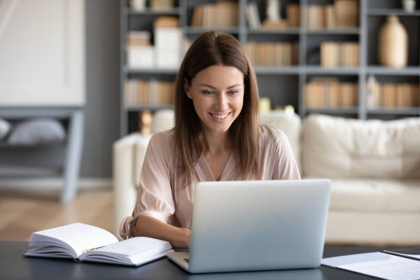 istock Young happy woman working on computer at home. 1217463753