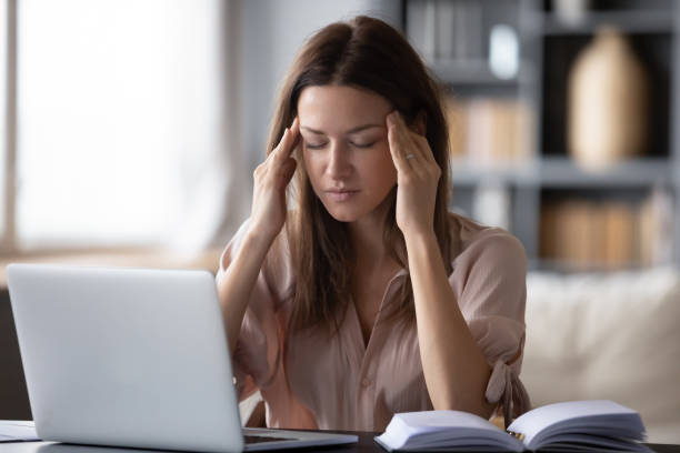 istock Unhealthy exhausted lady suffering from terrible headache. 1217463761
