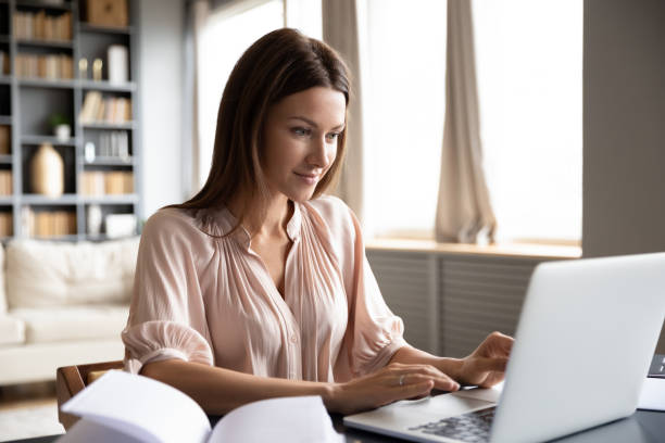 istock Pleasant happy young woman freelancer working on computer. 1217463779