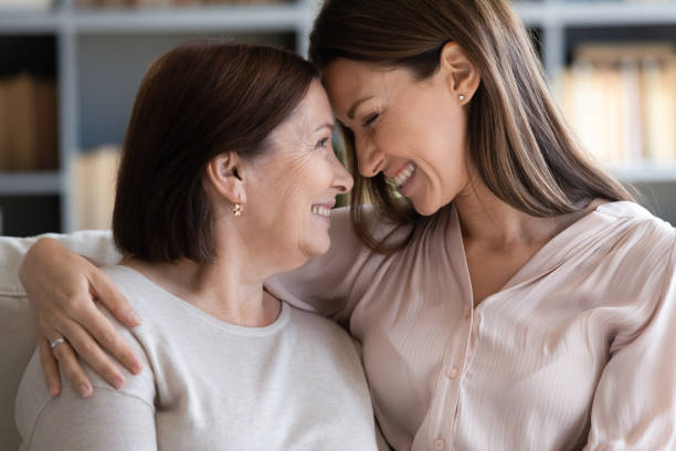 istock Happy grown up daughter touching foreheads with mother. 1217463799