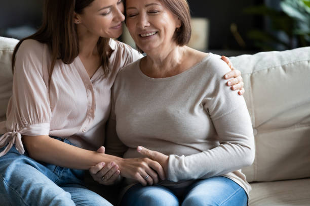istock Young affectionate woman embracing happy middle aged mother. 1217463800