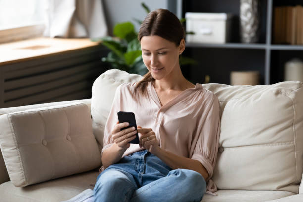 istock Happy pretty lady chatting in social network mobile applications. 1217463811