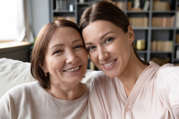 istock Web cam view young woman taking selfie with mother. 1217463835