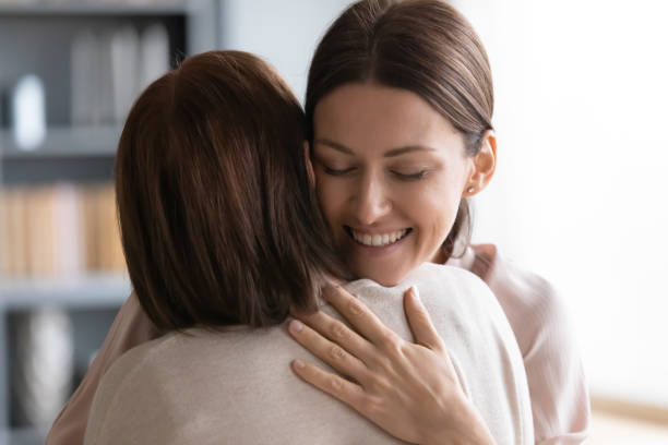 istock Affectionate young woman embracing middle aged brunette mother. 1217463845