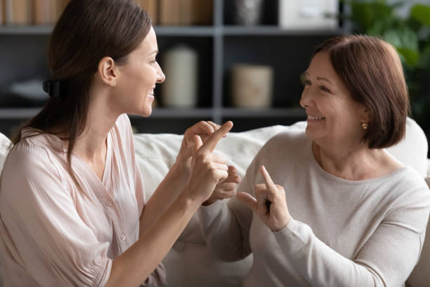istock Impaired disabled two generations family using sign language. 1217463848