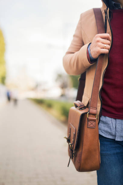 istock Close up of a briefcase on businessman shoulder. 1217463887