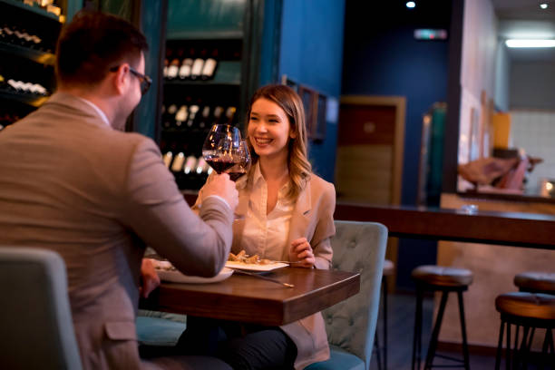 istock Young couple having a dinner in the restaurant and drinking red wine 1217463981