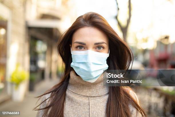 Portrait Of A Young Woman Wearing A Face Mask Stock Photo - Download Image Now - 20-29 Years, 2020, Adult