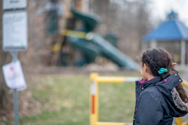 istock Little girl visits closed park. 1217467899