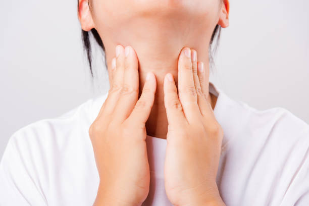 istock Asian beautiful woman Sore Throat or thyroid gland problem her useing Hand Touching Ill Neck on white background with copy space, Medical and Healthcare concept 1217469880