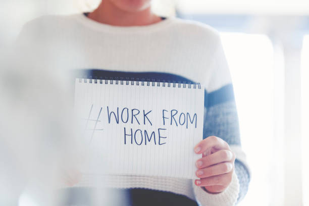 istock Woman holding a #workfromhome sign written on a pad. 1217471700