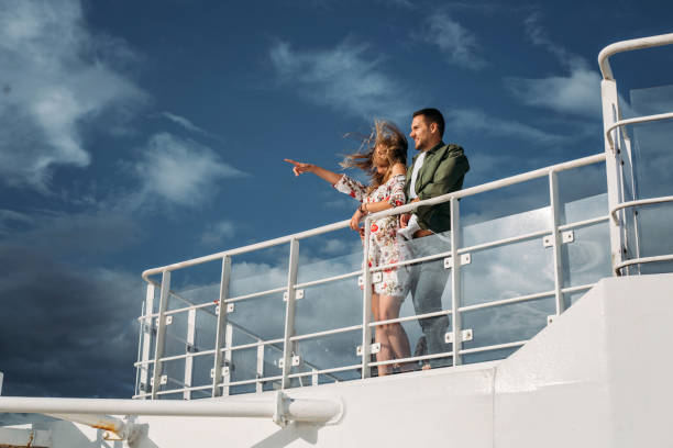 istock Beautiful romantic couple looking at view from a cruise ship 1217476156