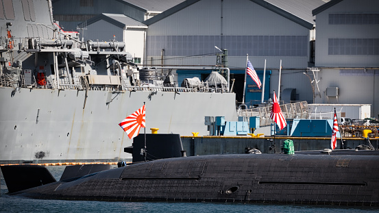 Japan Maritime Self-Defence Force submarines shares the dock with a US Navy Destroyer in the harbor at Yokosuka, Japan.