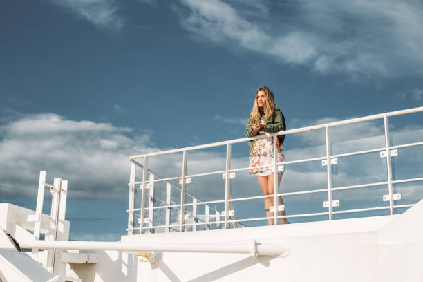 istock Beautiful young woman standing on a boat deck 1217476237