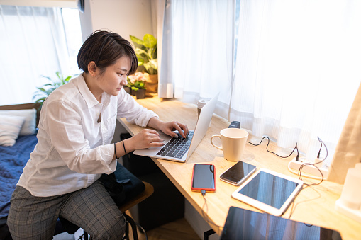 Young techie woman working at home
