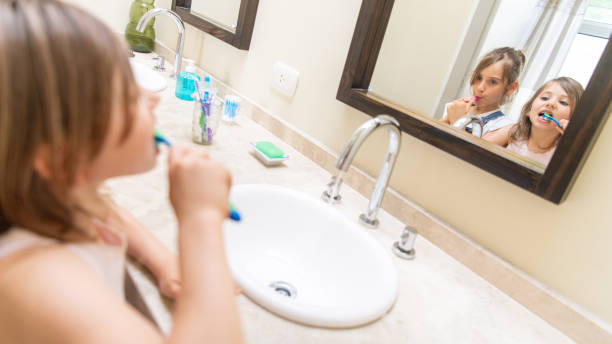 istock Sisters brushing teeth in the bathroom 1217477706