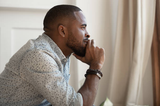 istock Close up view african guy touches chin thinks looking away 1217477766