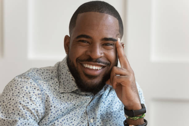istock Closeup portrait african guy smiling looking at camera 1217477769