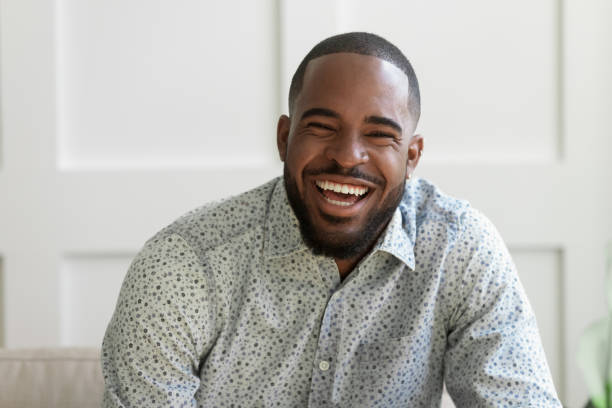istock African bearded man looking at camera laughing feels overjoyed 1217477774