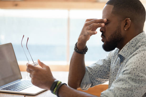 African guy took off glasses rub nose bridge reducing eyestrain