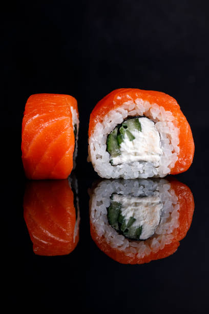 istock Philadelphia Sushi Roll on a black background with reflection. 1217478388