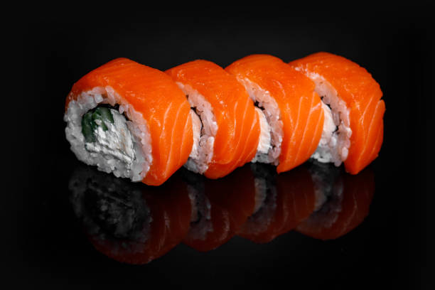 istock Philadelphia Sushi Roll on a black background with reflection. 1217478423