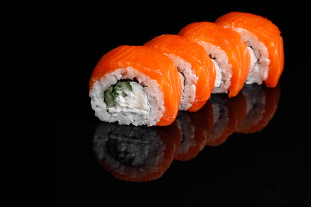 istock Philadelphia Sushi Roll on a black background with reflection. 1217478424