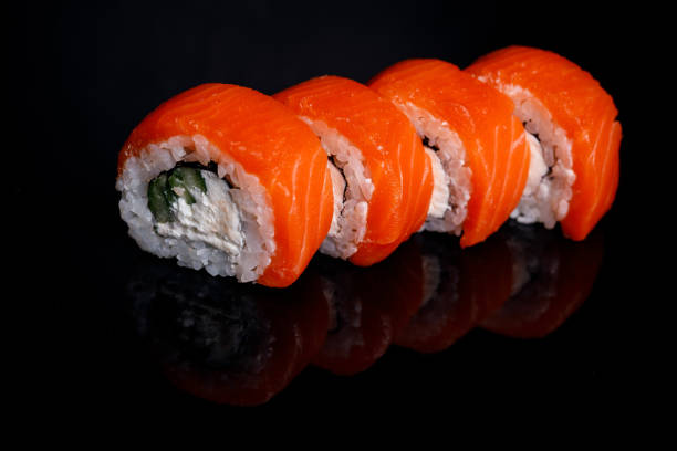 istock Philadelphia Sushi Roll on a black background with reflection. 1217478487