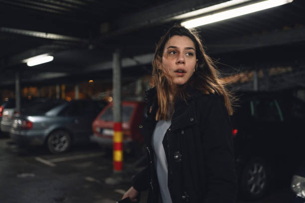 istock Terrified woman walking on a parking lot 1217478508