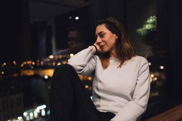 istock Young woman crying on a hotel window 1217478535